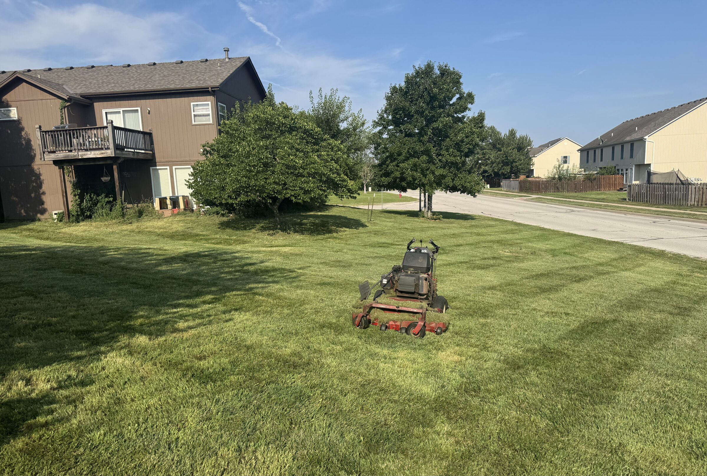 Twin Cut Services commercial mower on a freshly striped lawn